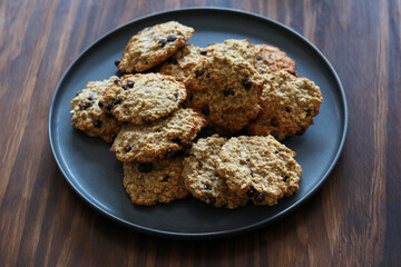 Homemade oatmeal banana cookies with chocolate chips on gray plate