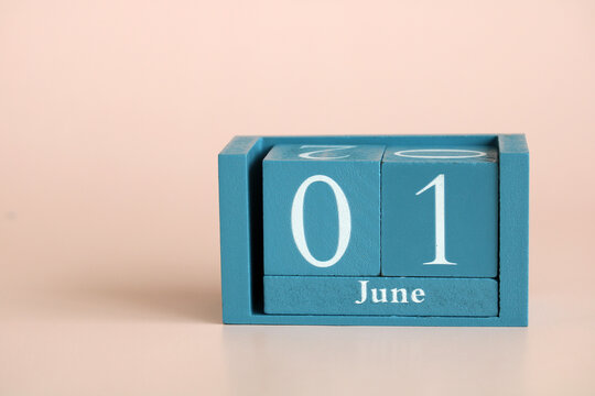 Teal wooden block calendar displaying june 1st date