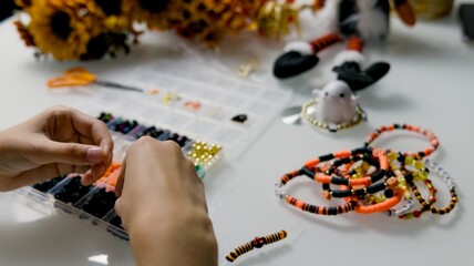 The child is preparing for Halloween, creating holiday decorations with their own hands.