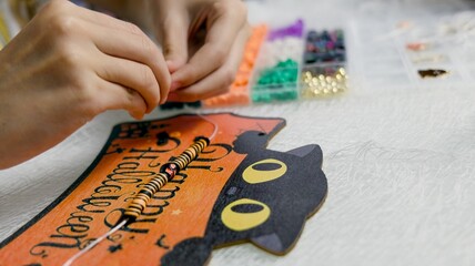 Obraz premium The child is preparing for Halloween, creating holiday decorations with their own hands.