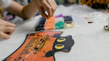 Fototapeta premium The child is preparing for Halloween, creating holiday decorations with their own hands.