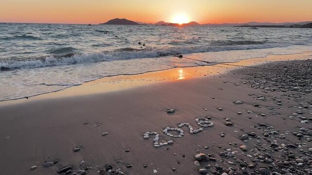 2026 written with stones on the beach. 2026 New Year concept.