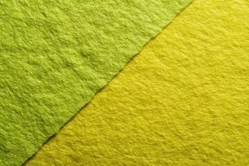 Two-toned fabric texture.  Close-up view of a vibrant lime green and mustard yellow fabric, meeting in a diagonal seam. The surface is slightly textured, with a visible, soft pile