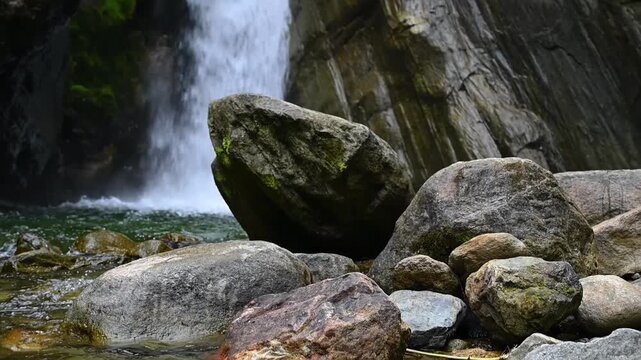 Cascada El Rocio Machay waterfall near Banos de Agua Santa in Ecuador. Flowing water cascades over rocks, creating a serene atmosphere in a lush natural setting with vibrant textures