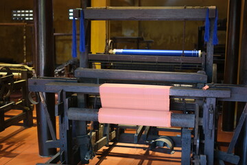 Cinematic video of silkworms hatching, feeding on mulberry leaves, spinning cocoons, and silk threads being reeled and woven into traditional Vietnamese textiles.