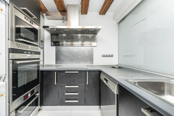Minimalist kitchen  that includes a storage area, integrated sink, and breakfast area