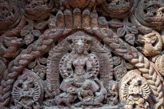 Intricate ancient stone carving depicting deities and mythical figures with elaborate details. Concept for spirituality, cultural heritage, and traditional craftsmanship.