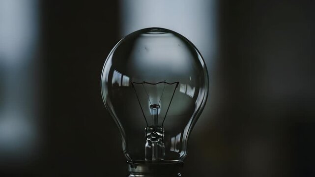 Close-up of glowing incandescent light bulb filament, classic electricity and energy awareness concept for Day of Energy Saving
