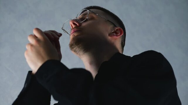 A young man clasps his hands and prays to God.
A prayer to Jesus Christ for a better life and good fortune.
A man asks God for good luck and mercy.
Faith. Priest, God, Christian, Catholic, Bible