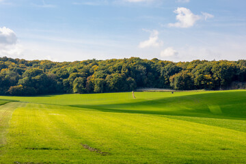 Autumn landscape, Terrain hilly countryside in Zuid-Limburg with green grass field, farmland and forest under blue sky, Epen is a village in southern part of the Dutch province of Limburg, Netherlands