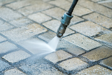 Dirty block pavement cleaning with high pressure washer