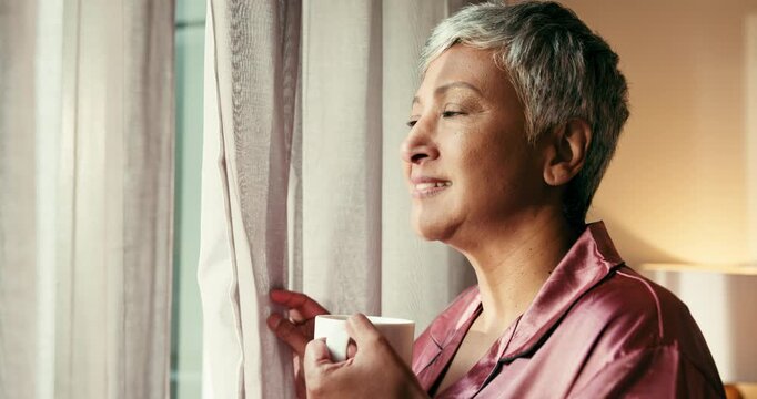 Coffee, smile and window with senior woman in home for memories, nostalgia and morning. Relax, thinking and wellness with happy mature person drinking caffeine beverage in apartment for weekend