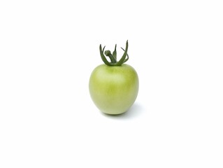 A Fresh green or unripe tomato isolated on white 
