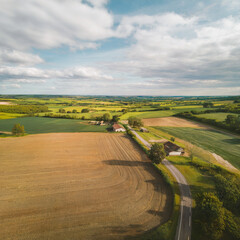 Farm landscape, agricultural fields, beautiful countryside, country road. Nature Illustration, photorealistic top view drone, horizontal banner.