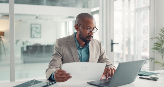 Reading, paperwork and man with laptop, office and typing financial analysis on website or statement. Serious, accountant and black person with document, review and info for business records or tech