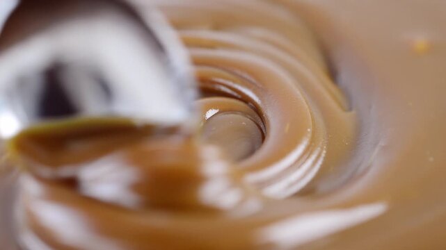 A spoon in dulce de leche. Traditional Argentinian sweet.
