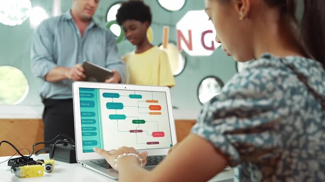 high school girl writing prompt while boy looking at teacher tablet. Cute academic student learning about coding and programming system. while happy teacher giving advice and comment pupil