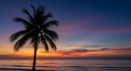 Obraz premium Silhouette of a Palm Tree Against a Vibrant Tropical Sunset Over the Ocean