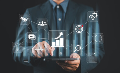 Business growth strategy and management. Businessman holding network structure and business icons.