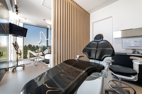 Modern dental office interior with reception desk, patient chairs, treatment rooms and professional equipment. Bright clean environment designed for healthcare and dentistry services, including x-ray 