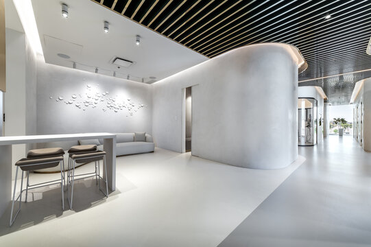 Modern dental office interior with reception desk, patient chairs, treatment rooms and professional equipment. Bright clean environment designed for healthcare and dentistry services, including x-ray 