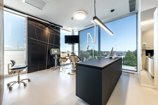 Modern dental office interior with reception desk, patient chairs, treatment rooms and professional equipment. Bright clean environment designed for healthcare and dentistry services, including x-ray 