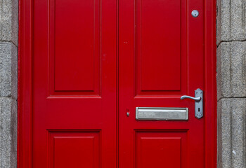 Colorful red door and the doorstep, the symbol of the city,  in the center of Dublin in Respublic Ireland