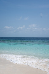 Clear waves on tropical sandy beach