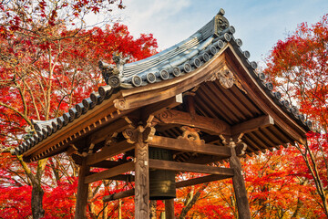 Traditional Japanese bell also known as Bonshō with maple tree background at Tenryū-ji Shrine in Kyoto. Japan