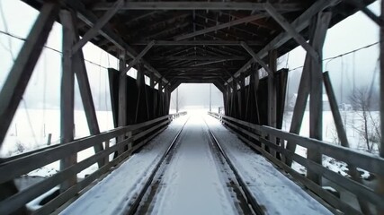 General Nature & Environment Snow-covered wooden bridge with moving train tracks in winter - Powered by Adobe