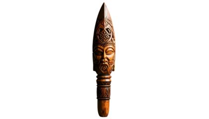 Carved wooden spear with detailed face, dark background