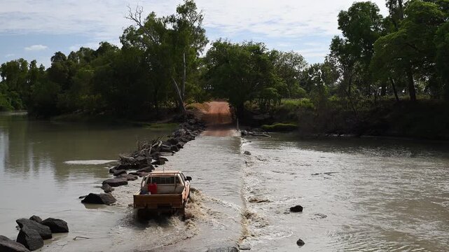 Big saltwater estuarine crocodile, Crocodylus porosus, lurking in shallow murky water of Cahills crossing waiting for Baramundi near Kakadu national park, Arnhemland, Northern Territory, Australia.