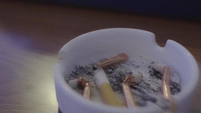 Close-up of ashtray with extinguished cigarette ashes