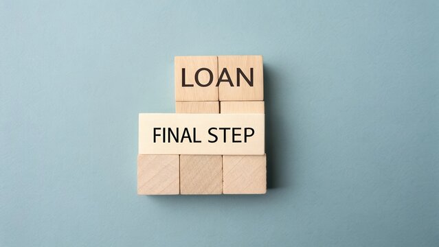 Wooden blocks displaying loan and final step message on a blue background represent financial decision and planning process