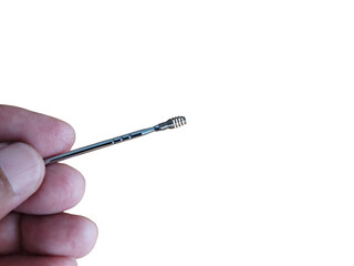 A hand holding ears pick metal, on a white background.