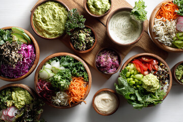Healthy buddha bowls with fresh vegetable and grain ingredients