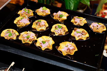 Mini Tostada Appetizers with Meat, Onion, and Cilantro on Black Tray