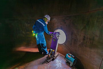 Male worker inspection floor scan tank oil of rust wall, loss of thickness bottom plate in the...