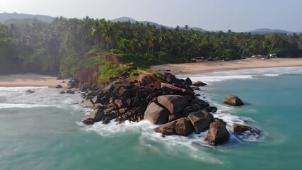 Aerial view of a rocky coast with silky long-exposure waves crashing on a tropical sandy beach - Powered by Adobe