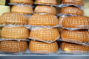 Delicious cheese rounds stacked in a market display