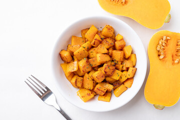 Top view of roasted butternut squash pumpkin in a bowl on white background, Autumn homemade food