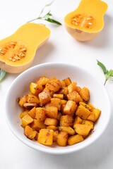Roasted butternut squash pumpkin in a bowl on white background, Autumn homemade food
