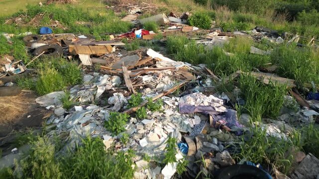 Plastic waste littering green meadow, representing environmental degradation and global ecological crisis devastating natural landscapes with synthetic debris