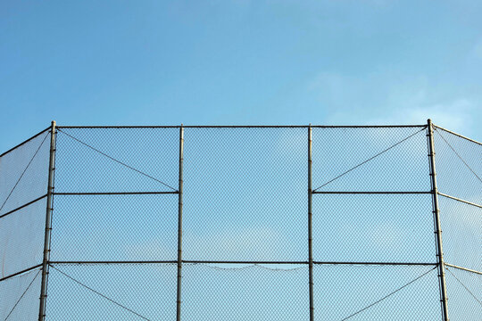 High fence around a baseball sports field