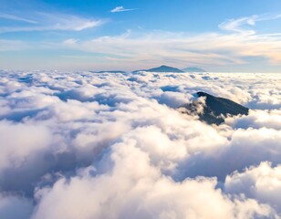 Aerial View of Clouds with Distant Mountains and Airplane Wing.