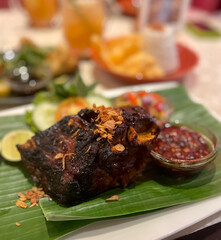 close up bokeh grilled beef ribs with sambal trasi and matah with indonesia traditional cooked style