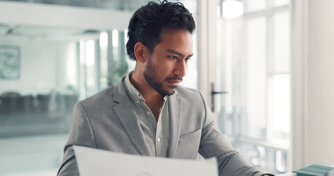 Computer, paperwork and business man in office for accounting, data entry or budget. Technology, reading document and serious bookkeeper at work for financial report, audit analysis and investment