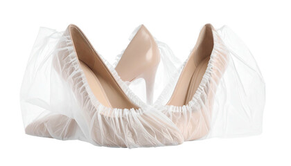 Two beige high-heeled shoes covered in clear protective shoe covers