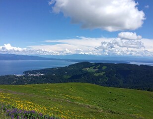 Obraz premium Scenic Vista of Mountains, Water, and a Sunny Sky