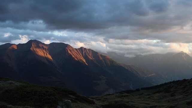 Mountain sunset in Swiss alps, warm evening golden light